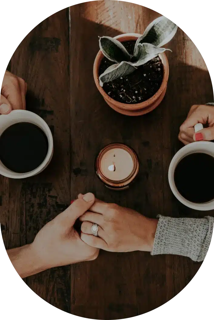 Holding hands over a coffee table - Melissa Rae Therapy Counselling Service